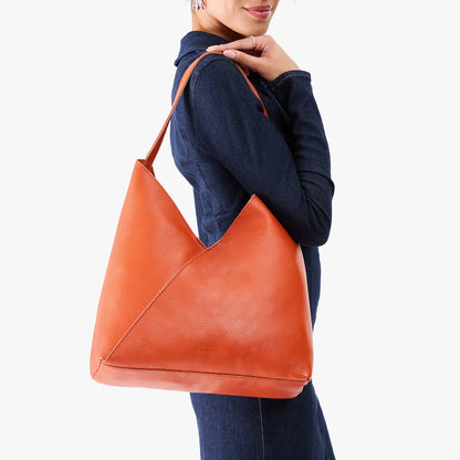 Koi*Oversized | Model wearing large shoulder bag with adjustable strap and magnetic snap closure
