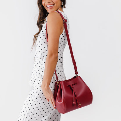 Chili Red | Model wearing bucket bag with cinched drawstring closure