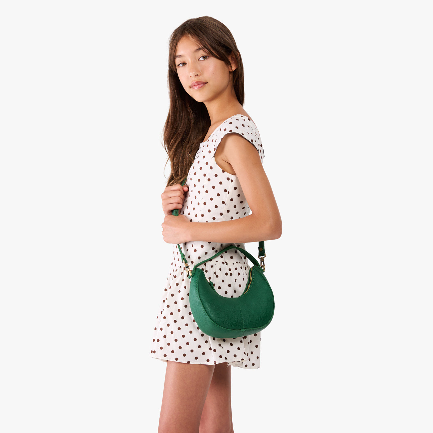 Bacalar | Model with a crescent shaped shoulder bag with zipper closure and gold accents