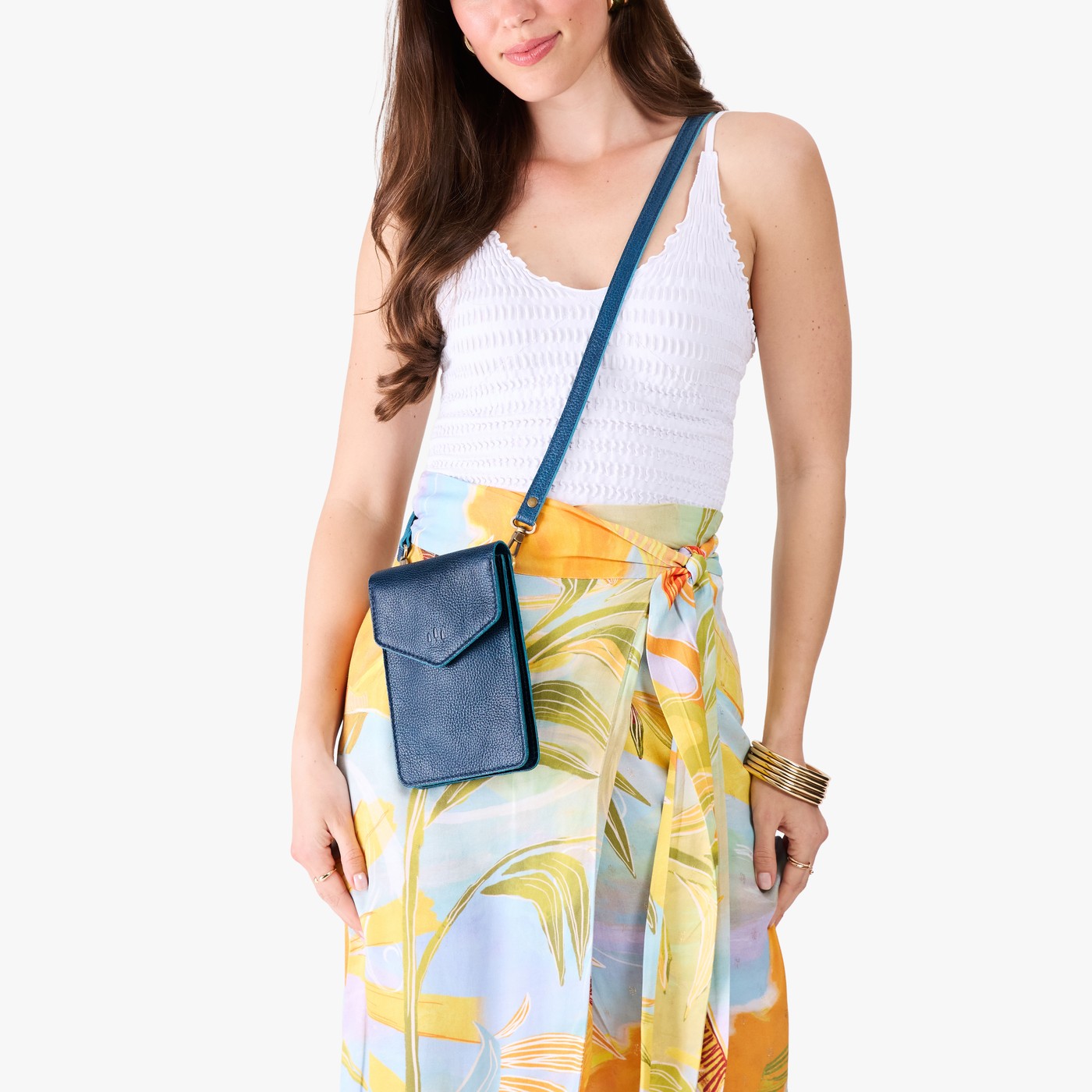 Caspian | Model wearing slim, phone-shaped crossbody purse with magnetic closure