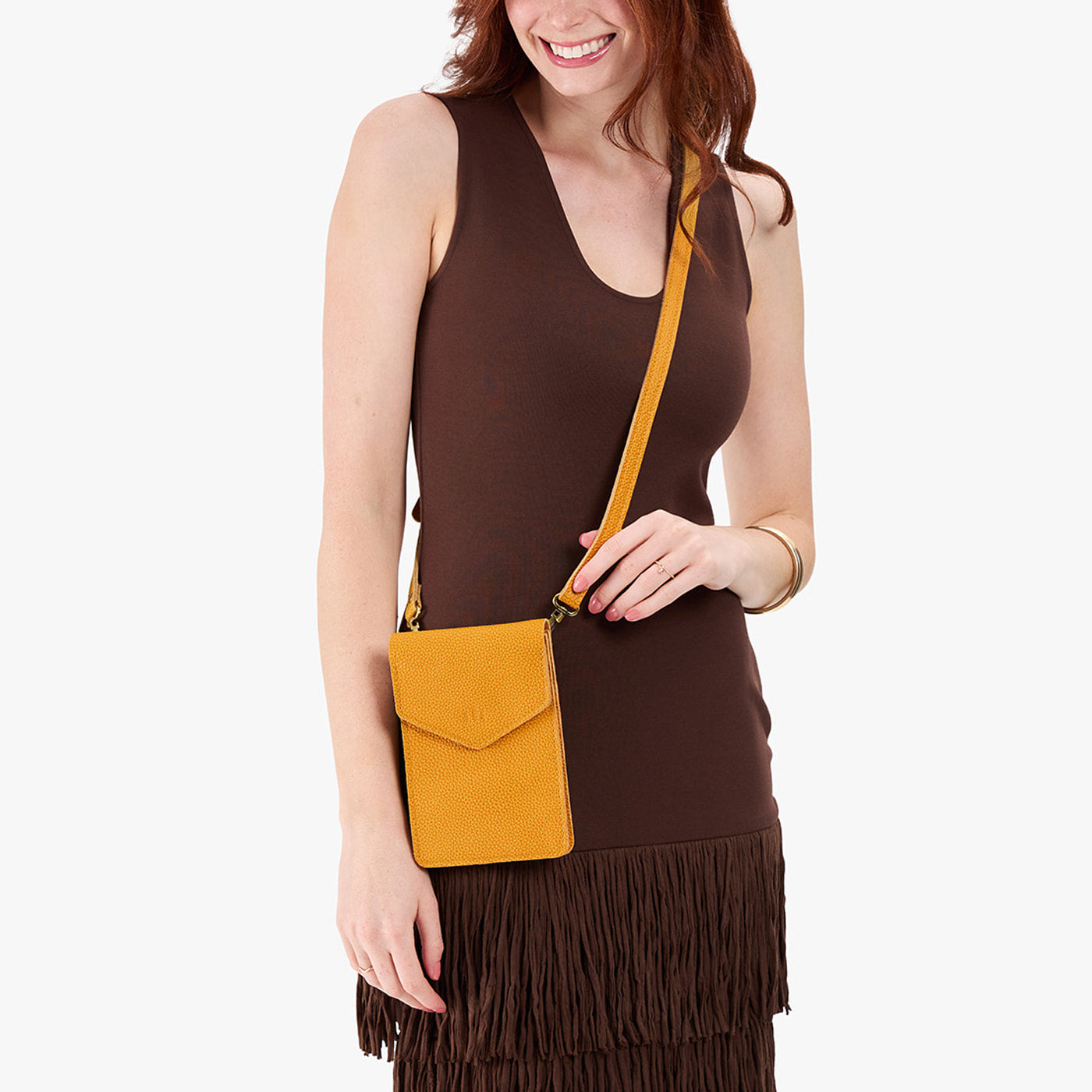 Sunshine | Model wearing slim, phone-shaped crossbody purse with magnetic closure