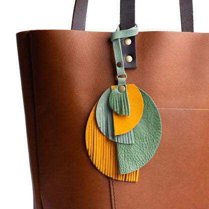 Toucan | Intricately cut leather shapes and fringe