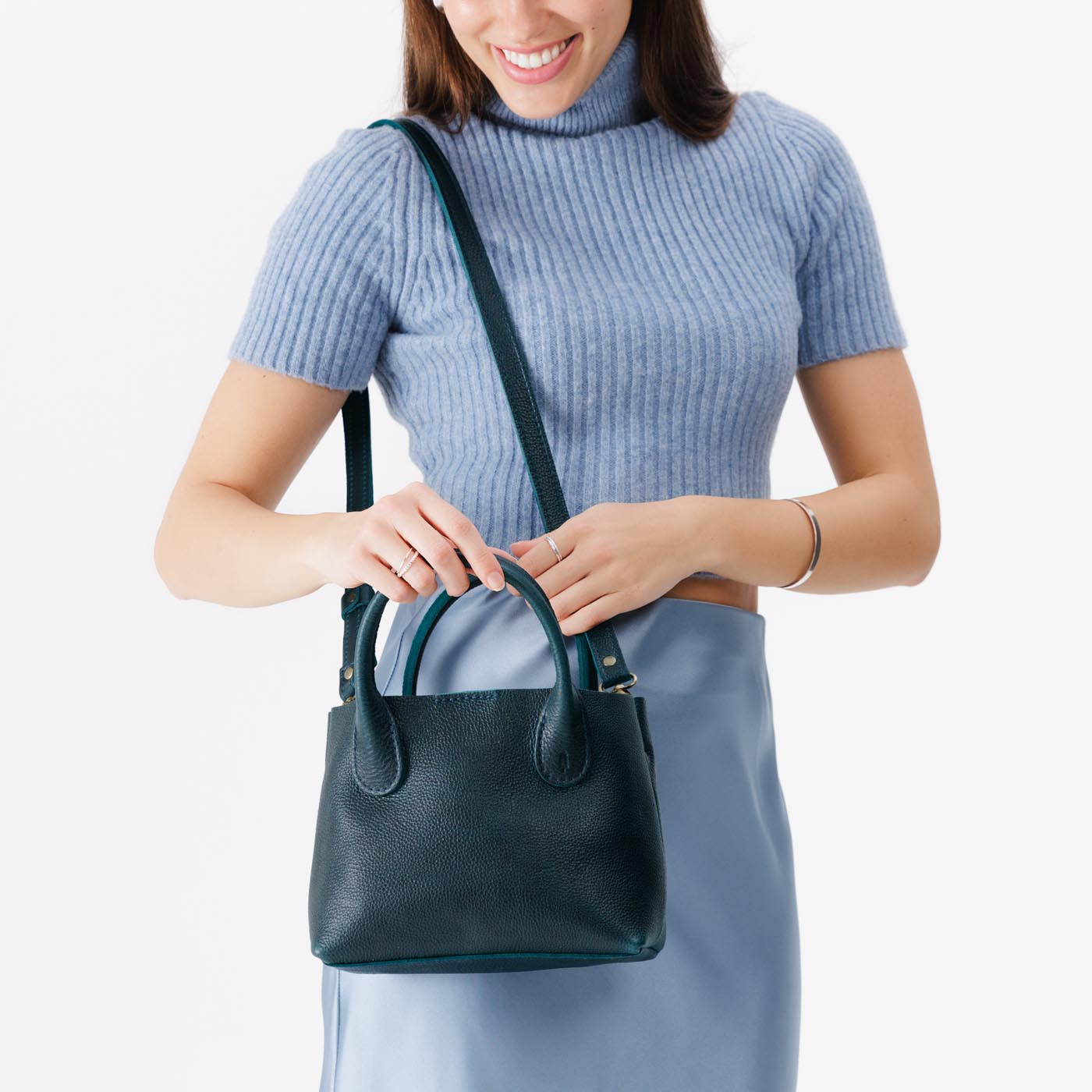 Boreal*Small | Model holding mid-size tote purse with structured leather handles and crossbody strap