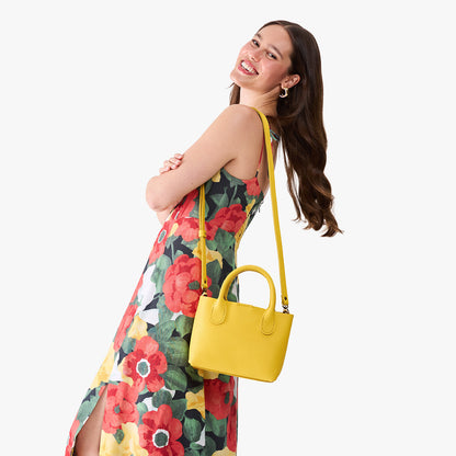 Canary*Small | Model wearing a petite tote purse with structured leather handles and crossbody strap