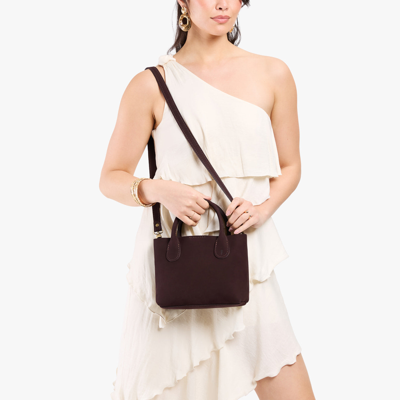 Velvet Brown*Small | Model holding petite tote purse with structured leather handles and crossbody strap