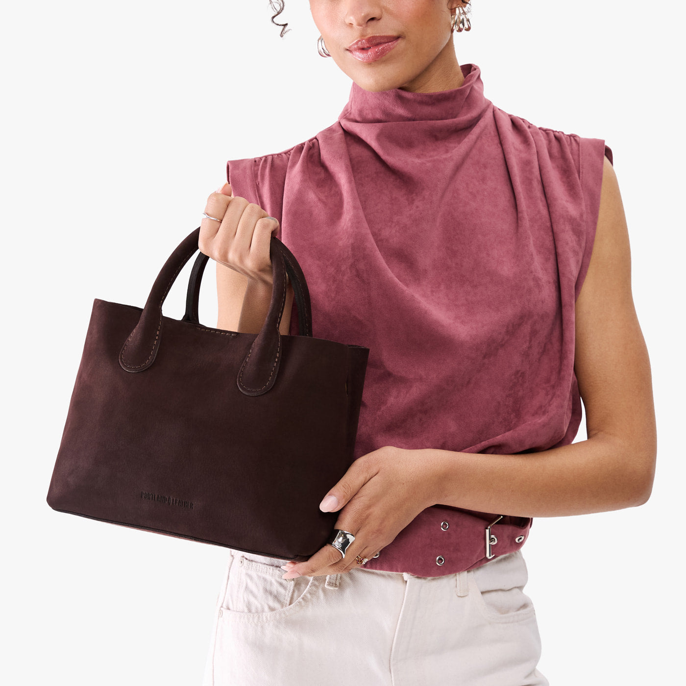 Velvet Brown*Large | Model holding mid-size tote purse with structured leather handles and crossbody strap
