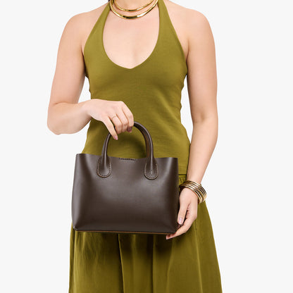 Grizzly*Large | Model holding mid-size tote purse with structured leather handles and crossbody strap