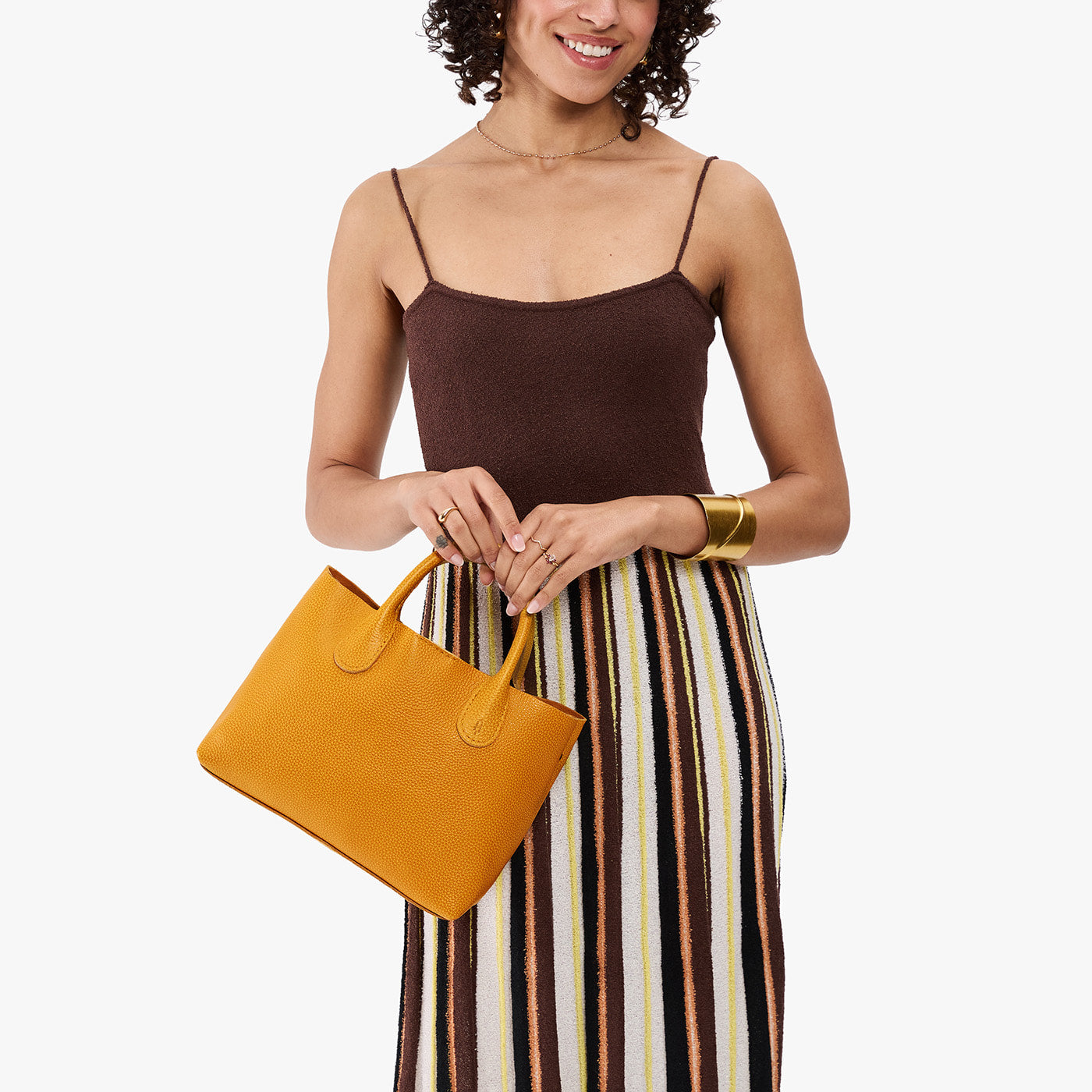 Sunshine*Large | Model wearing a mid-size tote purse with structured leather handles and crossbody strap