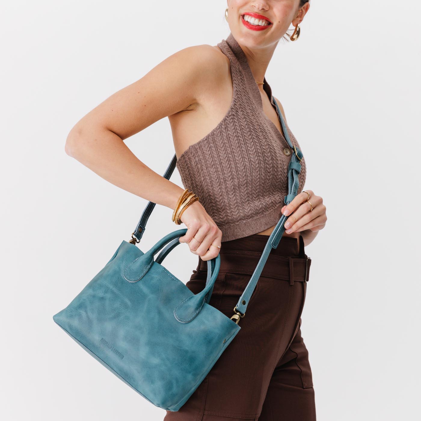 Aqua*Large | Model holding mid-size tote purse with structured leather handles and crossbody strap