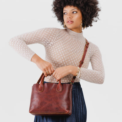 Cinnamon Bear*Large | Model holding mid-size tote purse with structured leather handles and crossbody strap