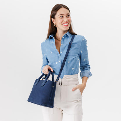 Deep Water*Large | Model holding mid-size tote purse with structured leather handles and crossbody strap