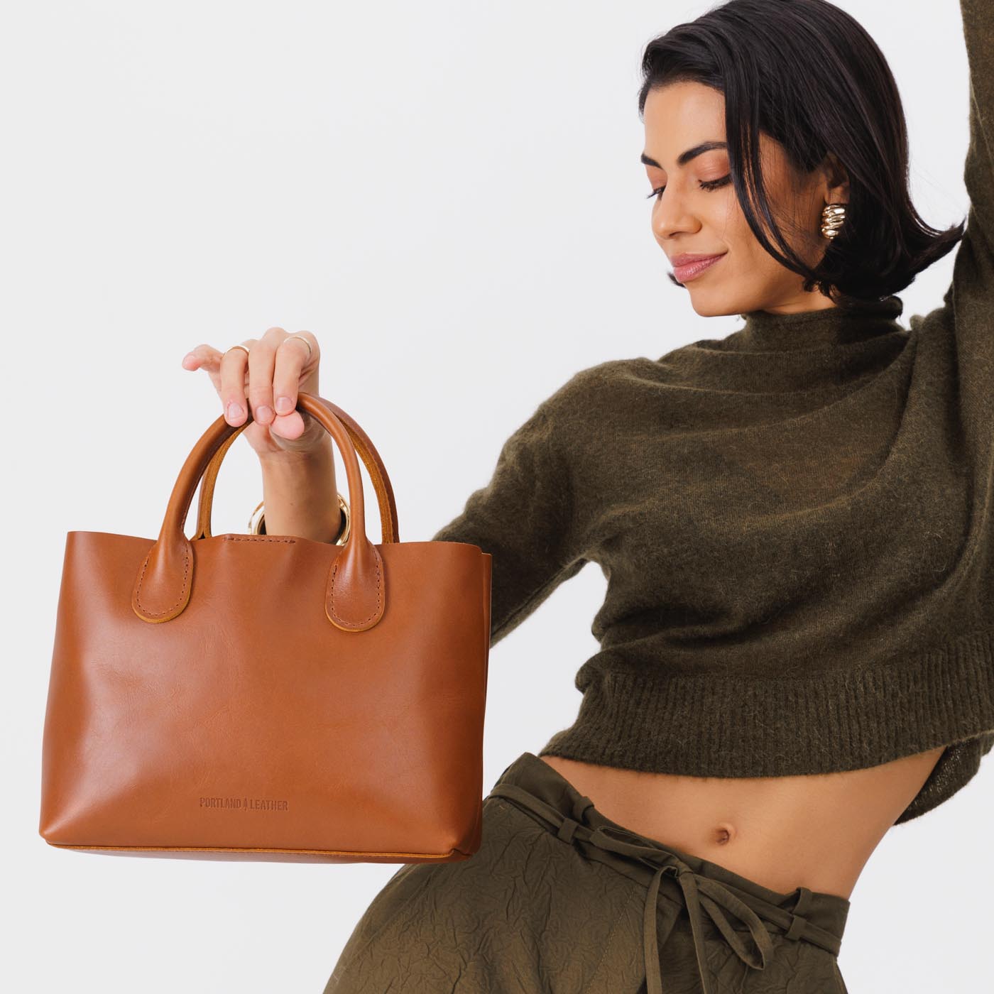 Honey*Large | Model holding mid-size tote purse with structured leather handles and crossbody strap