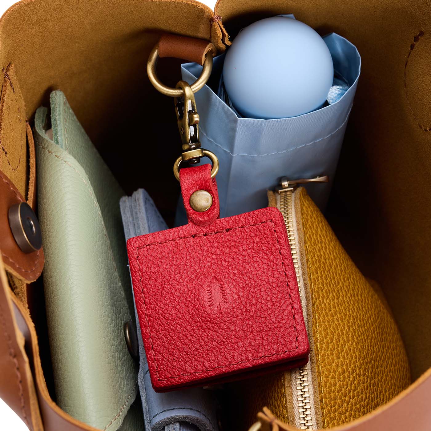 Cherry | Square-shaped leather AirTag holder with snap closure and swivel lobster claw clasp