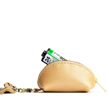 Champagne | Taco shaped leather pouch with zipper and swivel lobster clasp on white background