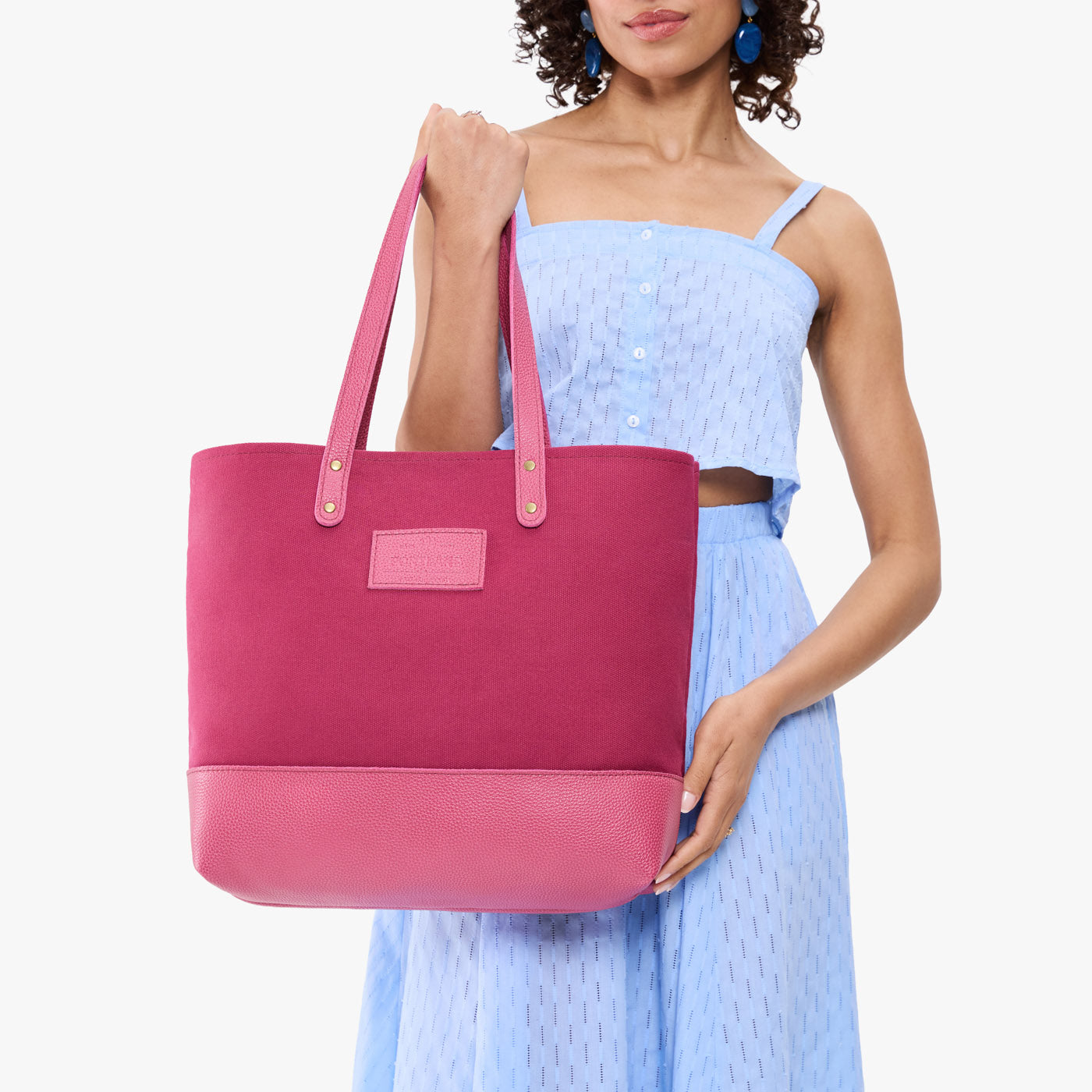 Rose Pop | Model holding canvas tote with leather base and handles