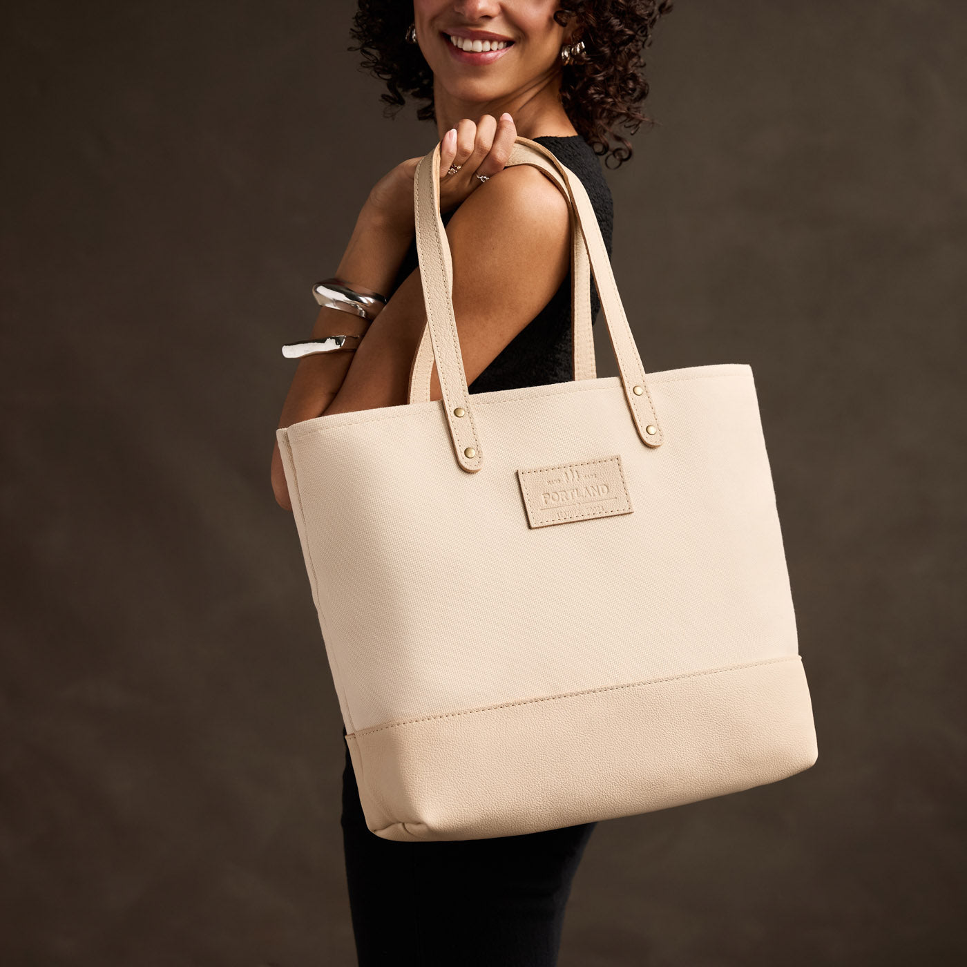 Warm Sand | Model carrying canvas tote with leather base and handles
