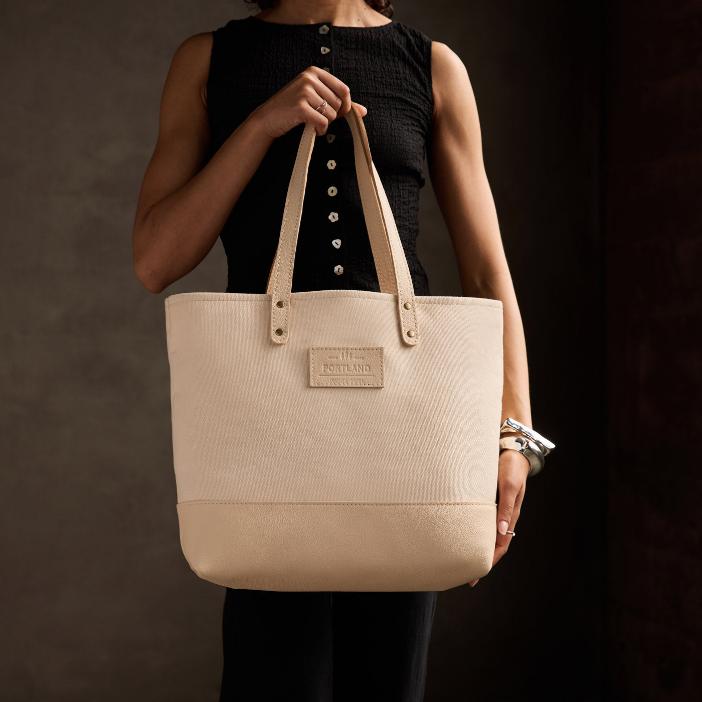 Warm Sand | Model holding canvas tote with leather base and handles