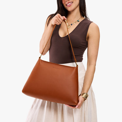 Honey*Large | Model holding large triangular shoulder bag with antiqued brass finished hardware