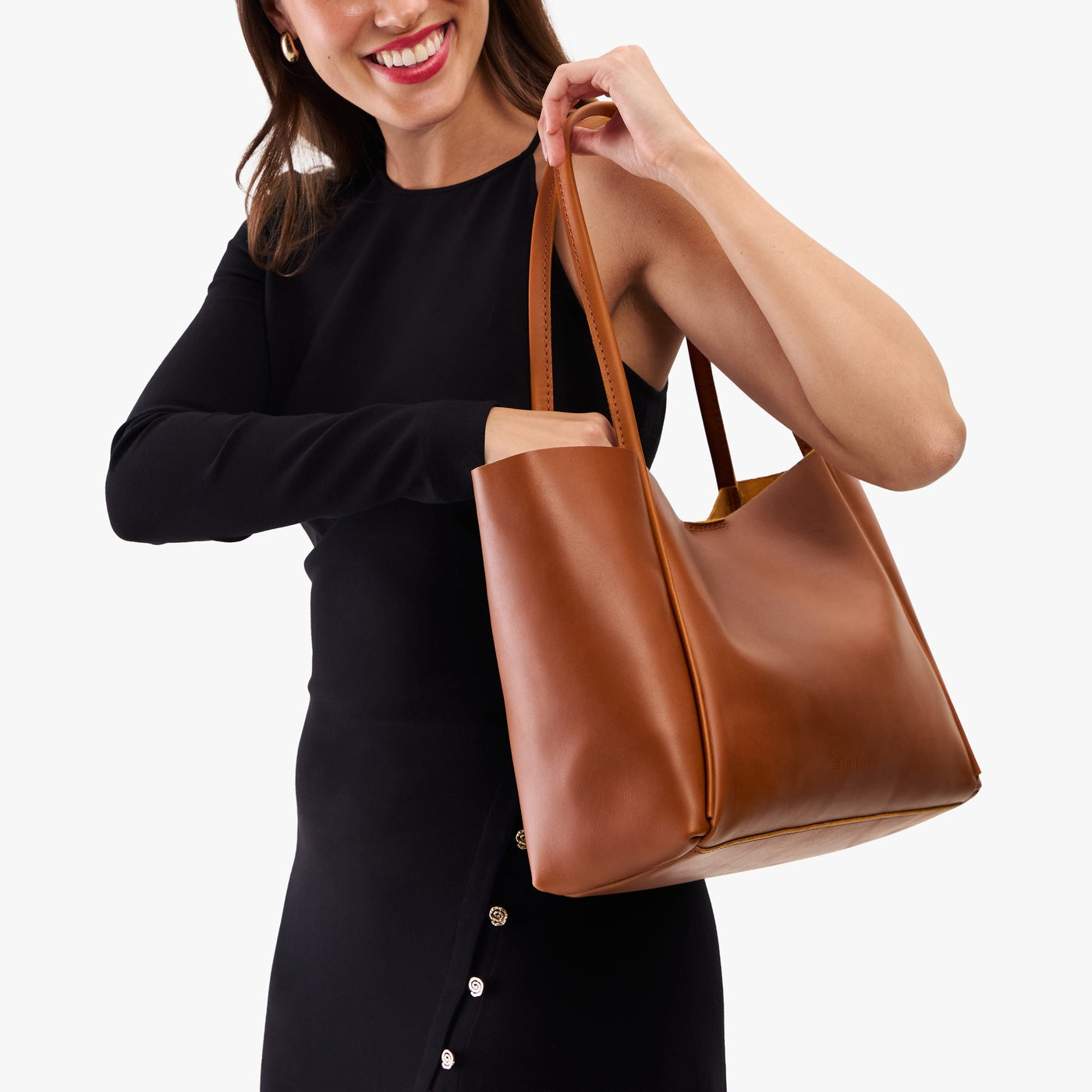 Honey*Large | Woman carrying a wide tote with leather straps and snap closure