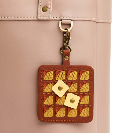 Waffle | Keychain shaped like a waffle with a swivel lobster clasp on a bag